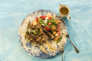 Lamb skewers with rocket melon strawberry salad