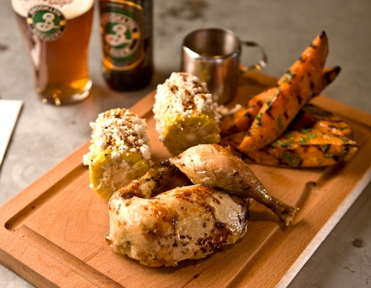 Rotisserie chicken with maple glazed sweet potato and elote corn on the cob