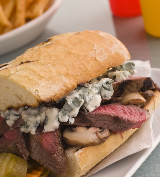 Toasted baguette minute steak with a mushroom and blue cheese sauce