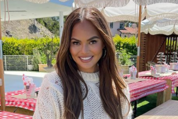 Chrissy Teigen posts family holiday snaps revealing blossoming baby bump