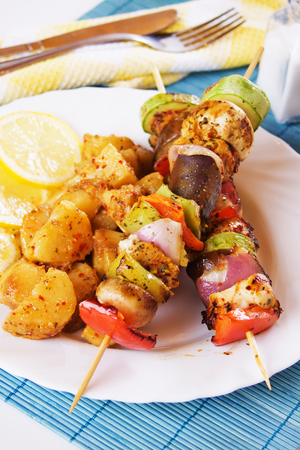 Pesto chicken kebabs with roasted vegetables