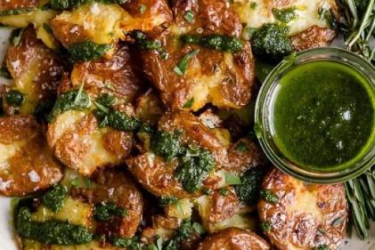 These parmesan smashed pesto potatoes are the side dish youve been dreaming of