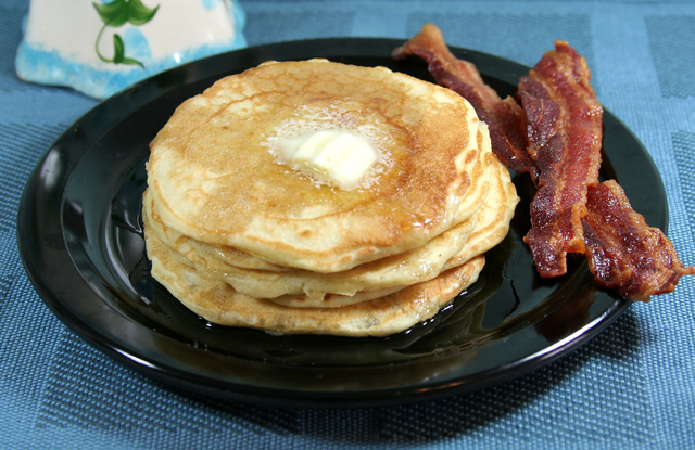 Banana pancakes with crispy bacon and syrup