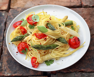 Pasta with roasted asparagus, cherry tomatoes and goats’ cheese.