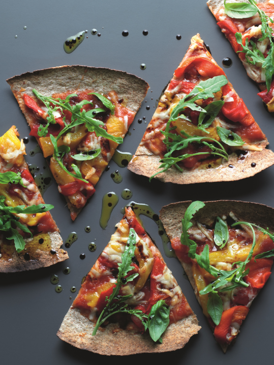 Tortilla pizza with tomatoes, pecorina cheese and rocket