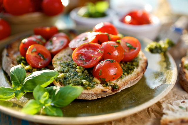 Garlic pesto toasts with cherry tomatoes