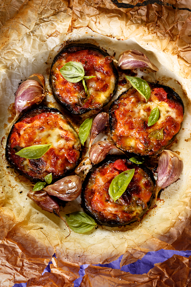 Garlic, tomato and melted cheese topped aubergines