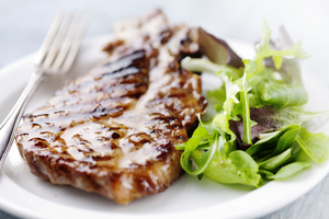 Juicy pork steaks with a simple green salad