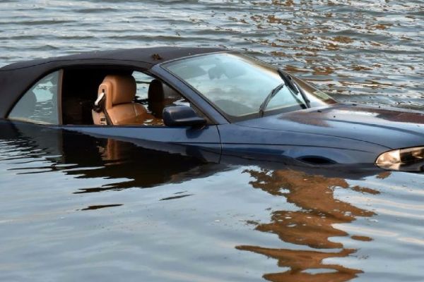 Dad saves his sons and their mum after their car plunges into...